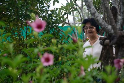 Portrait of woman on flowering plants