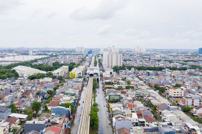 High angle view of street amidst buildings against sky