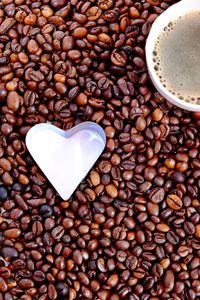 Roasted coffee beans with heart shape pastry cutter