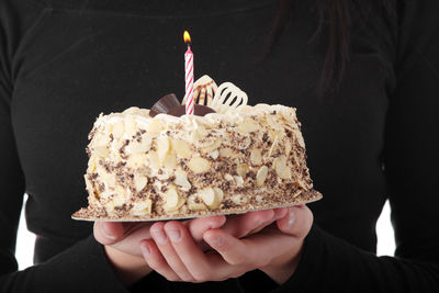 Midsection of person holding cake