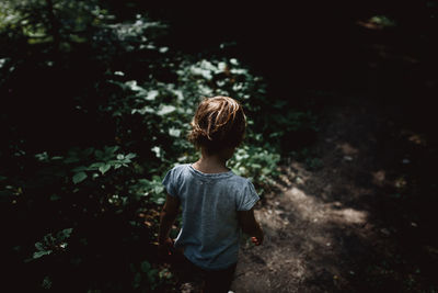 Child in the forest with nice morning sunlight on a hiking trail.