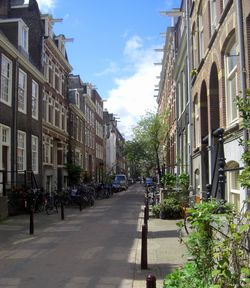 Road by buildings in city