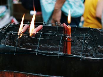 Close-up of man preparing food on barbecue grill