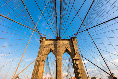 Low angle view of bridge against blue sky