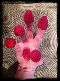 Close-up of hand holding pink flower