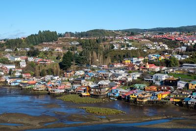 Town by buildings in city against clear sky