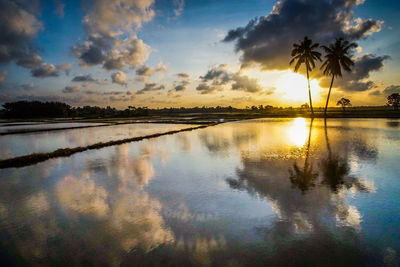 Scenic view of lake against sky during sunset