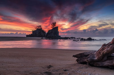 View of sea against cloudy sky at sunset