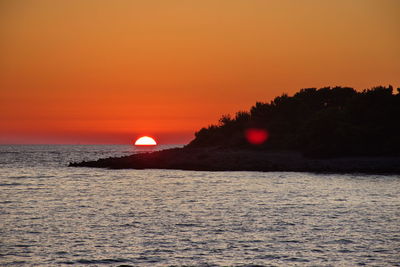 Scenic view of sea against romantic sky at sunset