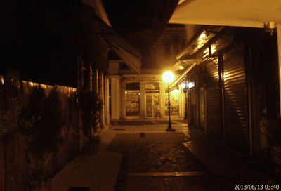 Illuminated underground walkway at night