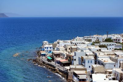 High angle view of houses by sea against clear sky