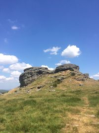 Rocks on field against sky