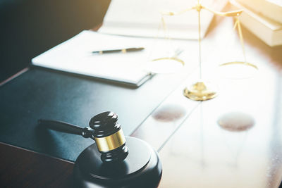 Close-up of gavel on table