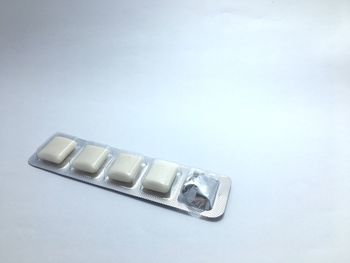 High angle view of telephone on table against white background