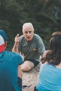 Rear view of man and woman against trees