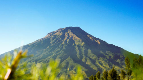 Low angle view of mountain against clear blue sky