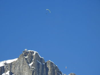 Low angle view of mountain against blue sky