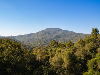Scenic view of mountains against clear blue sky