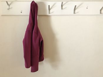 Close-up of clothes drying against white wall