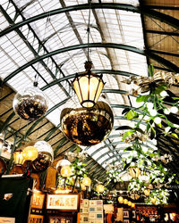 Low angle view of illuminated pendant lights hanging from ceiling