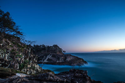 Scenic view of sea against clear blue sky