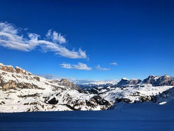 Scenic view of snowcapped mountains against blue sky