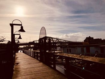 Bridge over river against sky during sunset