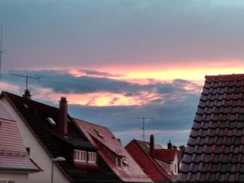 Low angle view of buildings against sky during sunset