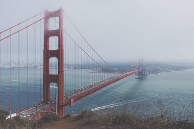 Suspension bridge over river in city