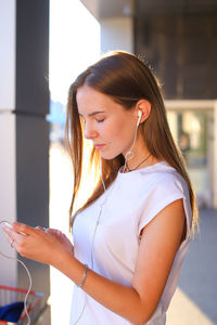 Young woman using mobile phone at home