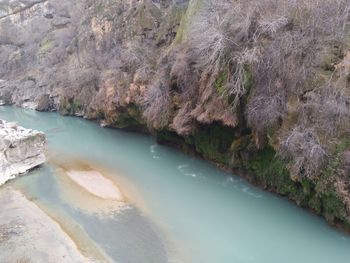 Scenic view of water by mountain