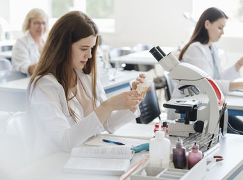 Researchers in white coats working in lab