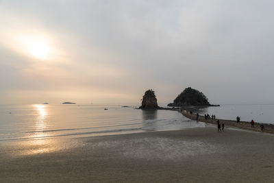 View of beach against cloudy sky