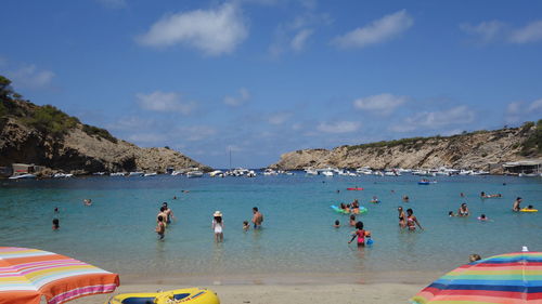 People swimming in sea at beach