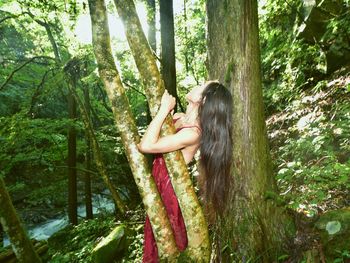 Side view of woman in forest