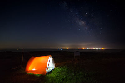 Scenic view of illuminated tent against sky at night