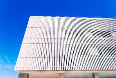 Low angle view of modern building against clear blue sky