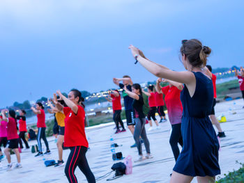 Group of people photographing with arms raised