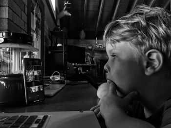 Boy video conferencing with family on digital tablet at table