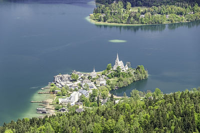 Aerial view of buildings and trees by sea