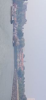 High angle view of buildings by sea against sky