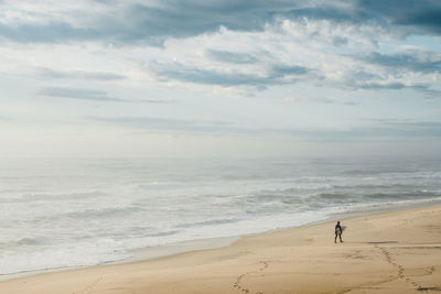 Scenic view of sea against cloudy sky