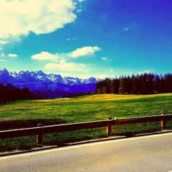 Scenic view of field against cloudy sky