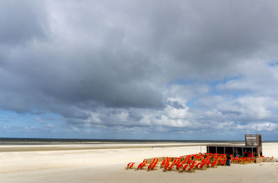 Lifeguard hut on beach against sky