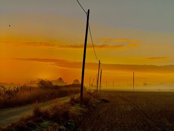 Scenic view of land against sky during sunset