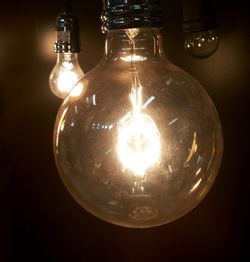 Close-up of lit light bulb