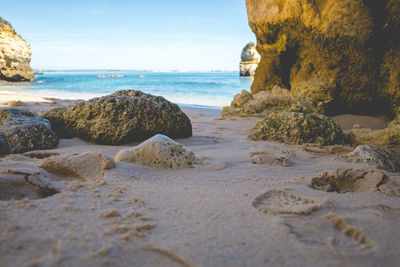 Rocks on beach against sky