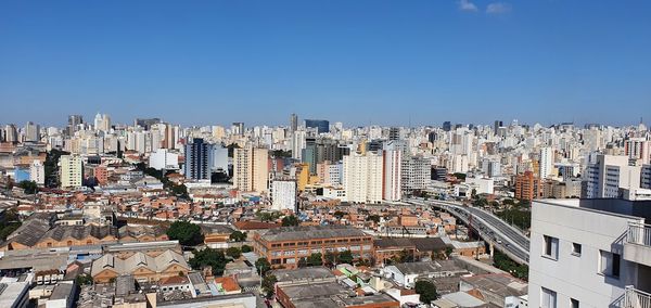 High angle view of buildings in city against clear sky