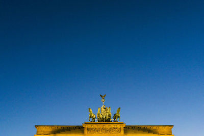 Low angle view of brandenburg gate against clear sky during sunset