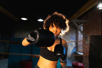 Portrait of young woman exercising in gym